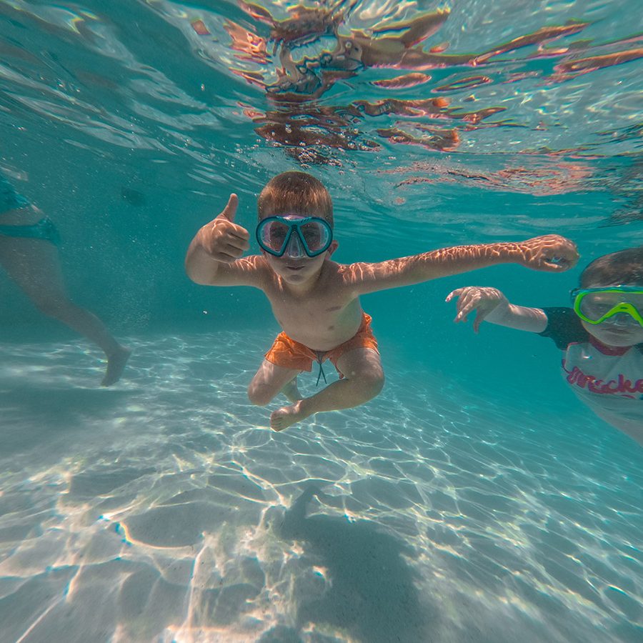 young child swimming