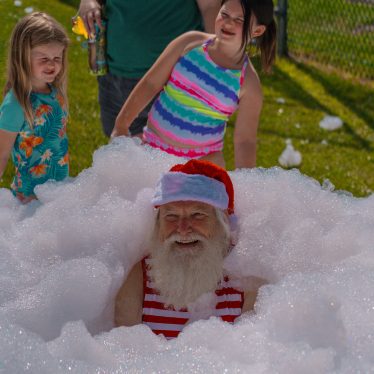 young girl, older man, santa, suds